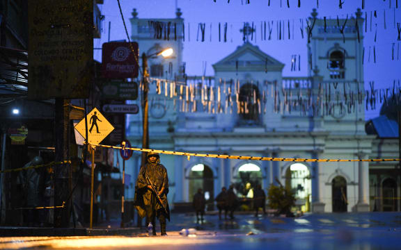 Sri Lankan soldiers stand guard under the rain at St. Anthony's Shrine in Colombo on April 25, 2019, following a series of bomb blasts targeting churches and luxury hotels on the Easter Sunday in Sri Lanka.