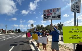 The anti-Trump protest took place in front of Oleai Beach Bar and Grill in San Jose, Saipan.