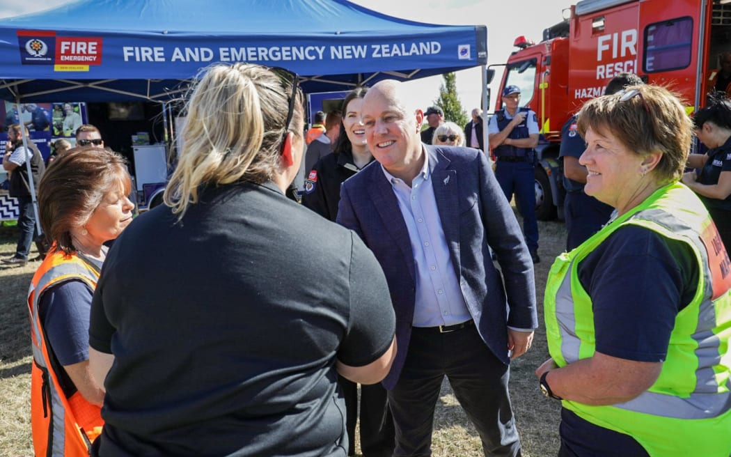 Prime Minister Christopher Luxon meets with emergency services and locals in Port Hills, Christchurch, on 22 February, 2024, after a fire burned through 650ha of land.