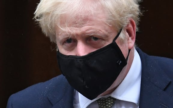 Britain's Prime Minister Boris Johnson wearing a face mask  leaves 10 Downing Street ion October 12, 2020 headed for the House of Commons, where he is set to announce a new Covid-19 alert system.
