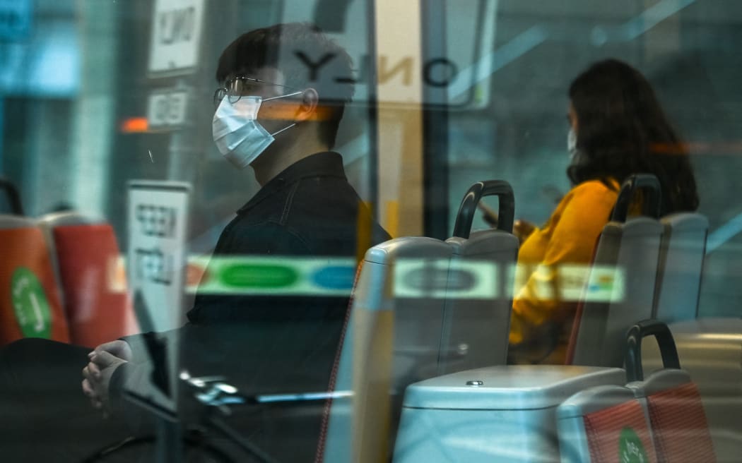 People wearing masks are seen on a tram during the first day of lockdown in Sydney, Australia.