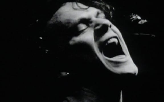 A black and white still shot of Shayne Carter from the 1992 music video for the single, 'Done'.