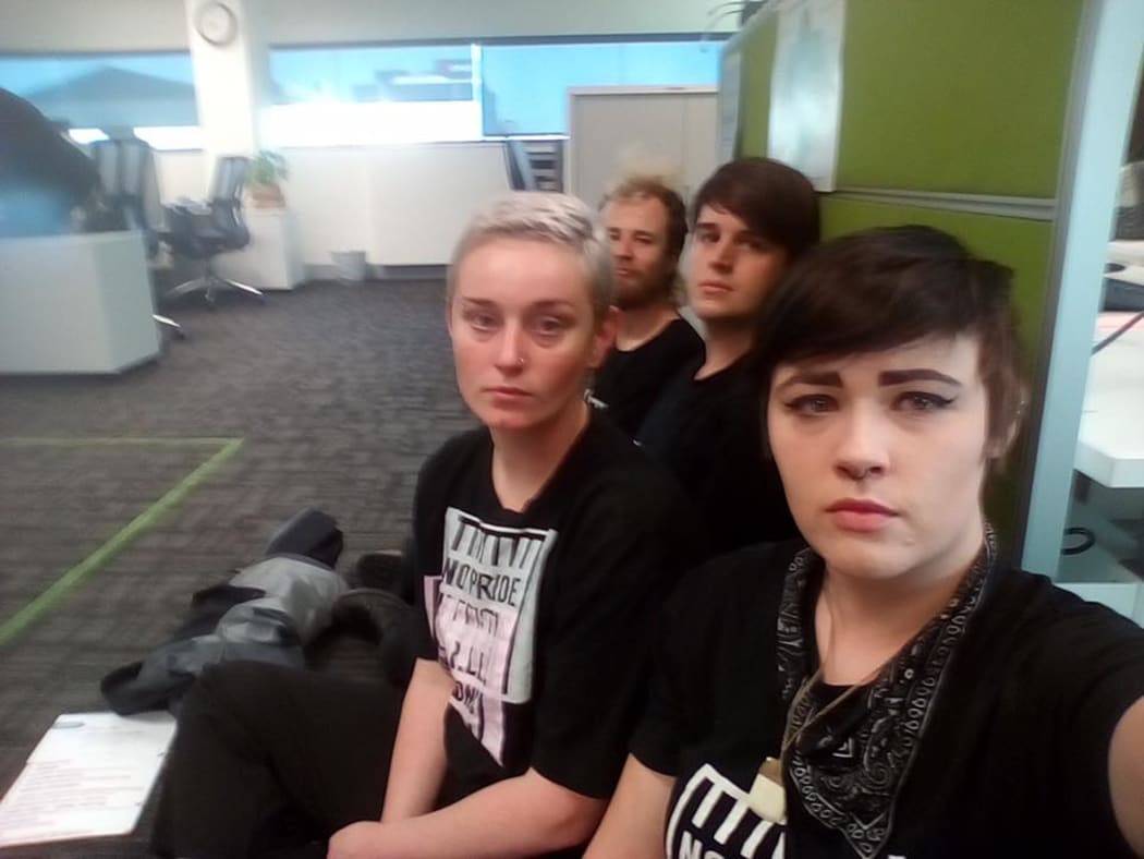 Four protesters were arrested after chaining themselves together at the Corrections office in Hamilton.