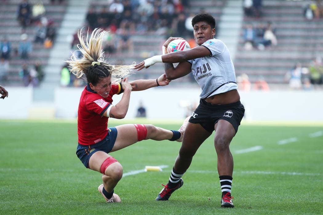 Fiji's Asinate Savu fends off the Spanish defence.