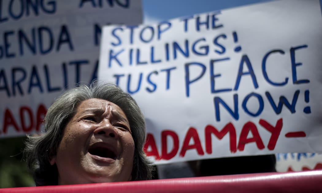 Activists hold a protest in front of Philippine National Police headquarters condemning what they call extra-judicial killings related to President Duterte's campaign against drugs.
