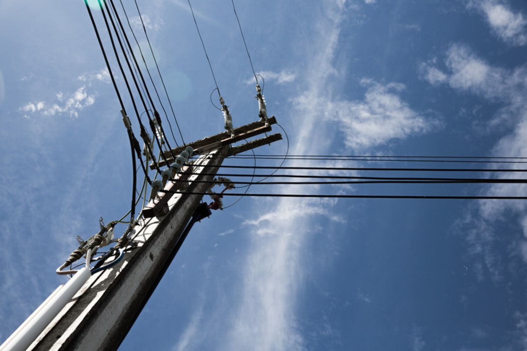 Power lines against a bright blue sky.