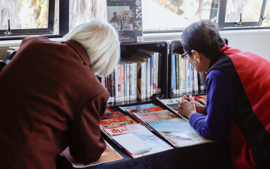 Elders choosing books at Deverton House Rest Home