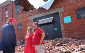 ATLANTA, GEORGIA - SEPTEMBER 30: Republican presidential nominee, former U.S. President Donald Trump, speaks with Katie Watson and Patrick Watson, owners of Chez What Furniture store that was damaged during Hurricane Helene on September 30, 2024 in Valdosta, Georgia. Trump met with local officials, first responders, and residents who have been impacted by last week's hurricane which has left at least 90 people dead across Florida, Georgia, North Carolina, South Carolina, and Virginia. Millions are still without power, water, or reliable communications. U.S. President Joe Biden and Democratic presidential nominee, U.S. Vice President Kamala Harris have spoken with local leaders and stated that they plan to visit affected areas when the time is right.   Michael M. Santiago/Getty Images/AFP (Photo by Michael M. Santiago / GETTY IMAGES NORTH AMERICA / Getty Images via AFP)