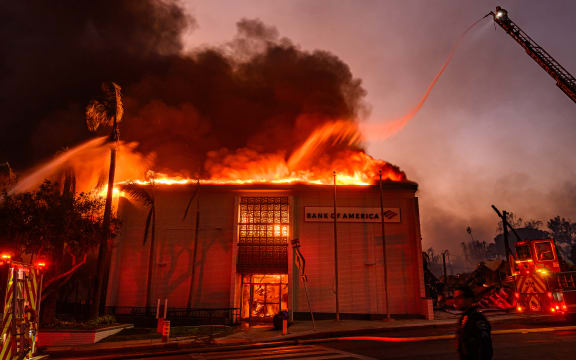 A Bank of America is fully engulfed in flames along Lake Ave. during the Eaton fire in the Altadena area of Los Angeles county, California on January 8, 2025. At least five people are now known to have died in wildfires raging around Los Angeles, with more deaths feared, law enforcement said January 8, as terrifying blazes leveled whole streets, torching cars and houses in minutes.
More than 1,000 buildings have burned in multiple wildfires that have erupted around America's second biggest city, forcing tens of thousands of people from their homes. (Photo by JOSH EDELSON / AFP)