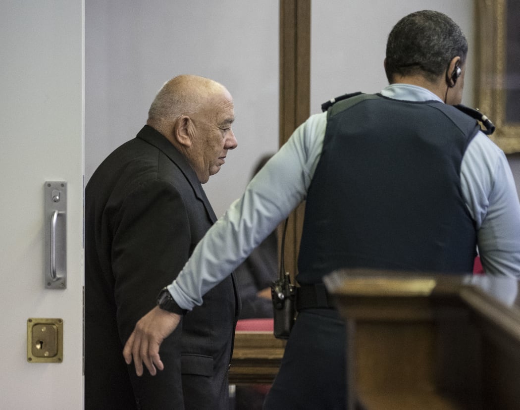 Sir Ngatata Love is escorted by a guard during his trial in the High Court in Wellington on 6 October 2016.