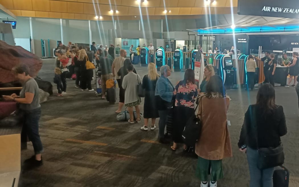 People queued up at Wellington Airport to reschedule flights after a severe thunderstorm caused all flights to Auckland Airport to be cancelled.