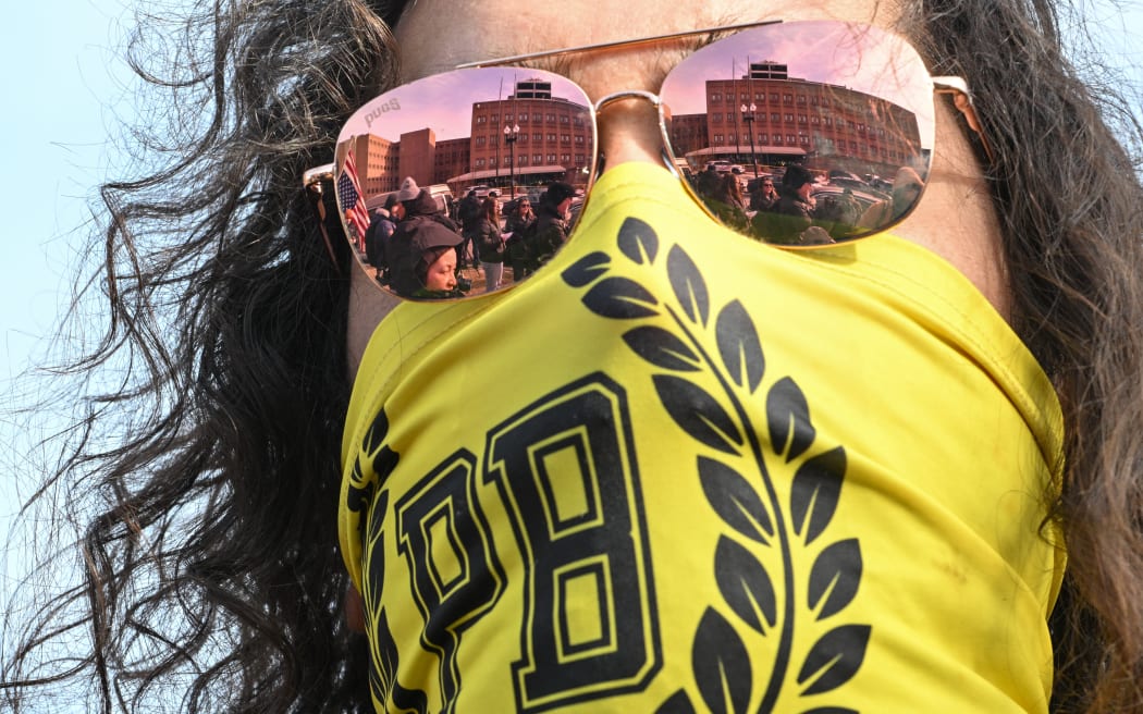 A man identifying himself as a member of the "Proud Boys" gathers with demonstrators outside the DC Central Detention Facility, where some defendants from the January 6, 2021 attack on the US Capitol are being held, in Washington, DC, on January 21, 2025. On his first day in office, US President Donald Trump signed pardons for more than 1,500 people charged in the January 6, 2021 attack on the Capitol by his supporters trying to overturn the 2020 election. (Photo by ROBERTO SCHMIDT / AFP)