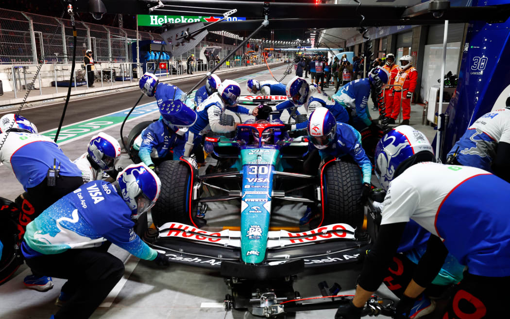 The crew of Liam Lawson Visa Cash App RB Formula One Team services his car on pit road during the 2024 Las Vegas Grand Prix.