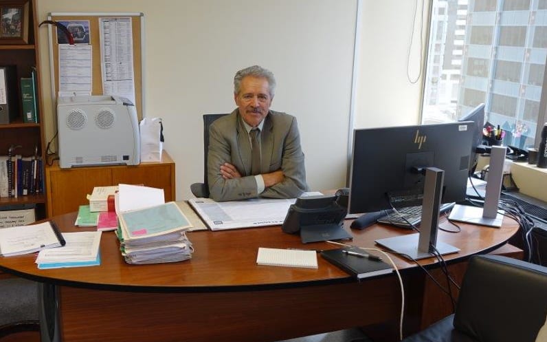 Chief Judge Wilson Isaac, the chair of the Waitangi Tribunal, sitting at his desk in Wellington.