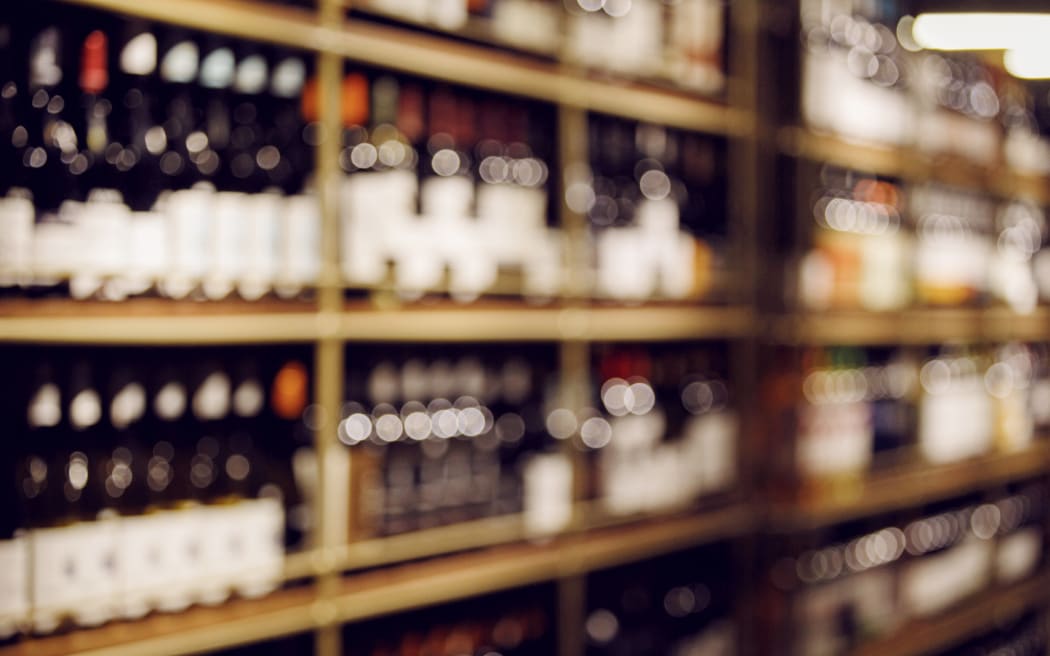 Blurred photo of wine bottles on shelves