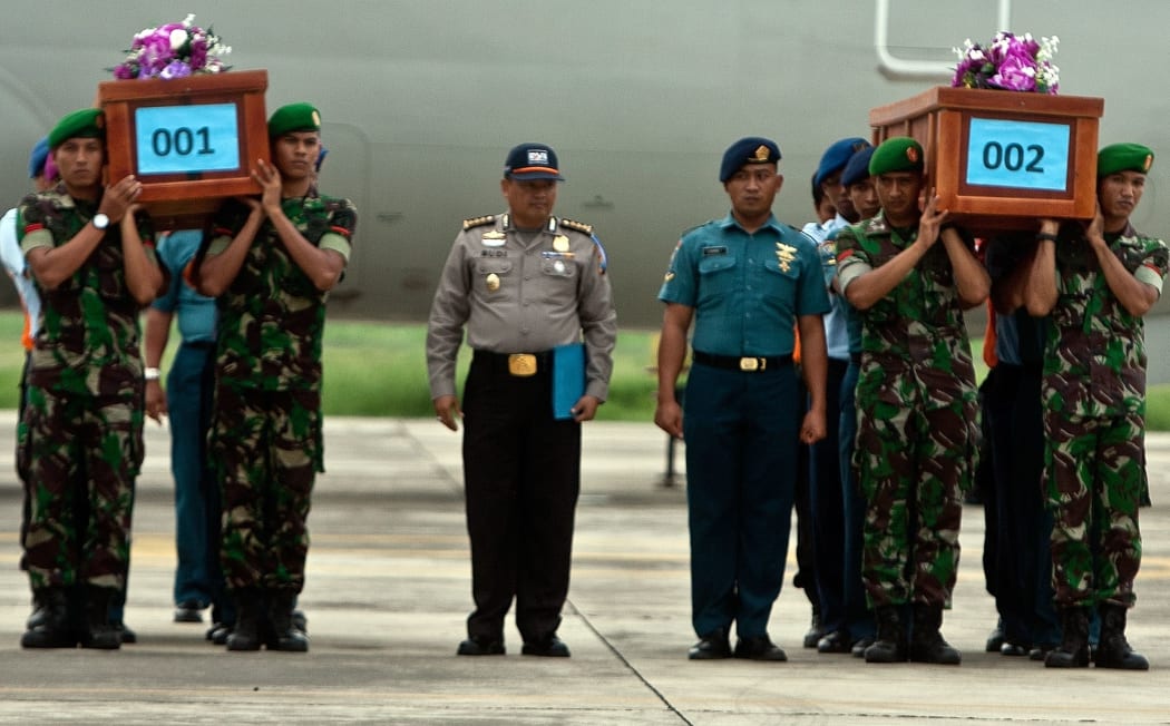 Indonesian military personnel carry coffins of victims recovered from AirAsia flight QZ8501.