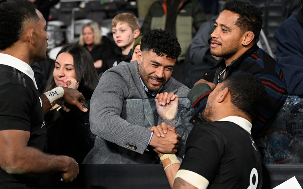 Richie Mo'unga talks to All Blacks players after the first test against England in Dunedin.