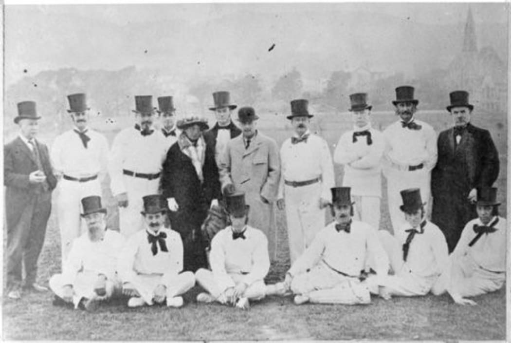 The parliamentary cricket team, Basin Reserve, Wellington, 1915. Lord Liverpool (Governor General) and Lady Liverpool stand in the centre. Sir Joseph Ward (the then PM) stands 4th from the right. All the players are wearing formal top hats and loose bow ties with their cricket whites.