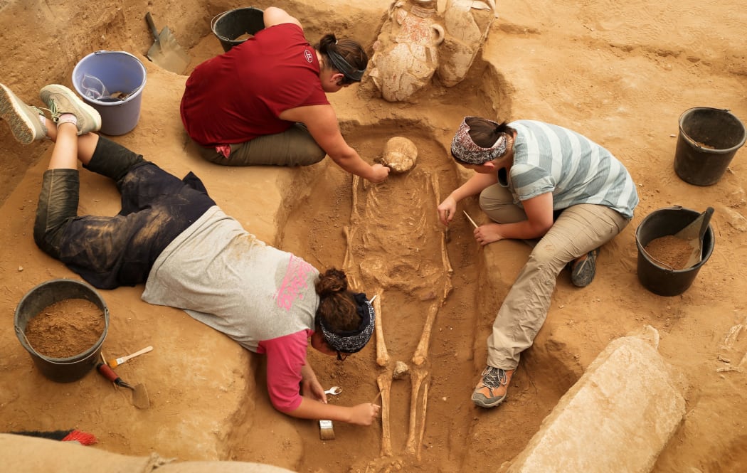 A team of foreign archaeologists extract skeletons at the excavation site of the first Philistine cemetery ever found on June 28, 2016 in the Mediterranean coastal Israeli city of Ashkelon.