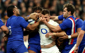 French players tackle England's Henry Slade.