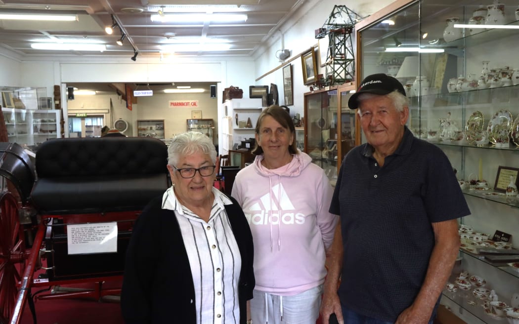 Picture of three individuals posing for a photo.