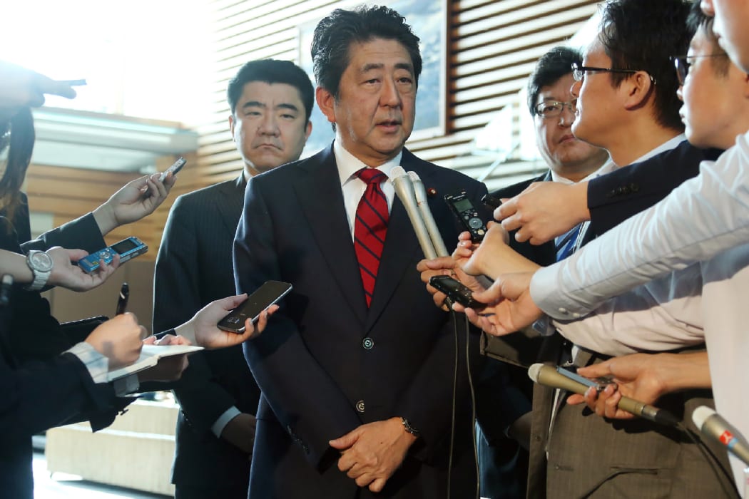 Japan's Prime Minister Shinzo Abe (centre) speaks to reporters at his official residence in Tokyo after the latest test.