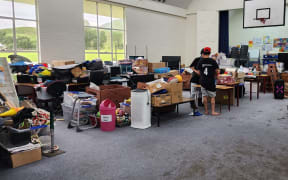 Nūhaka School classroom items piled up off muddy carpets.