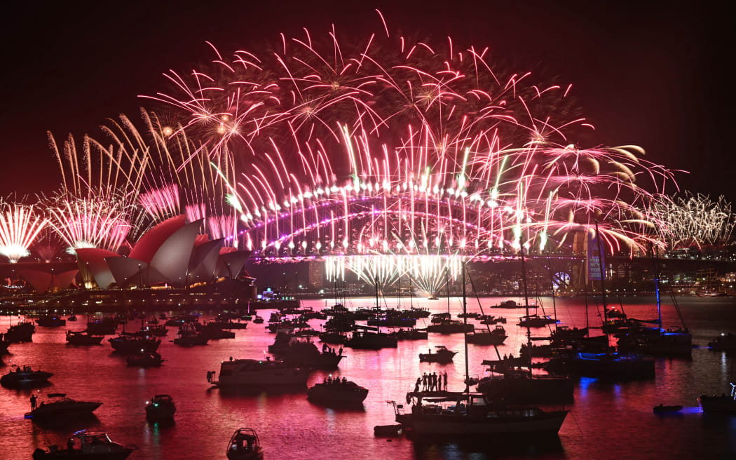 Fireworks light up the midnight sky over Sydney Harbour Bridge and Sydney Opera House during 2025 New Year’s Day celebrations in Sydney on January 1, 2025. (Photo by Saeed KHAN / AFP)