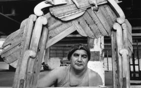 Maori artist Selwyn Muru in his workshop with the Waharoa sculpture. Muru is a sculptor, film-maker, composer, and broadcaster.