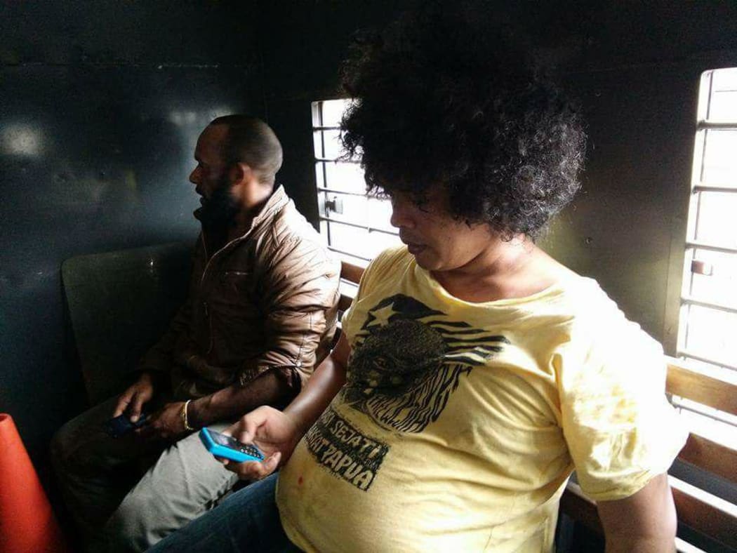 Surya Anta (Spokeperson of FRI West Papua) and AMP leader in police car after arrested