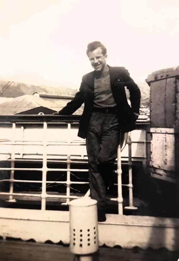 A photo of Baden Norris in front of a tug boat at Lyttleton