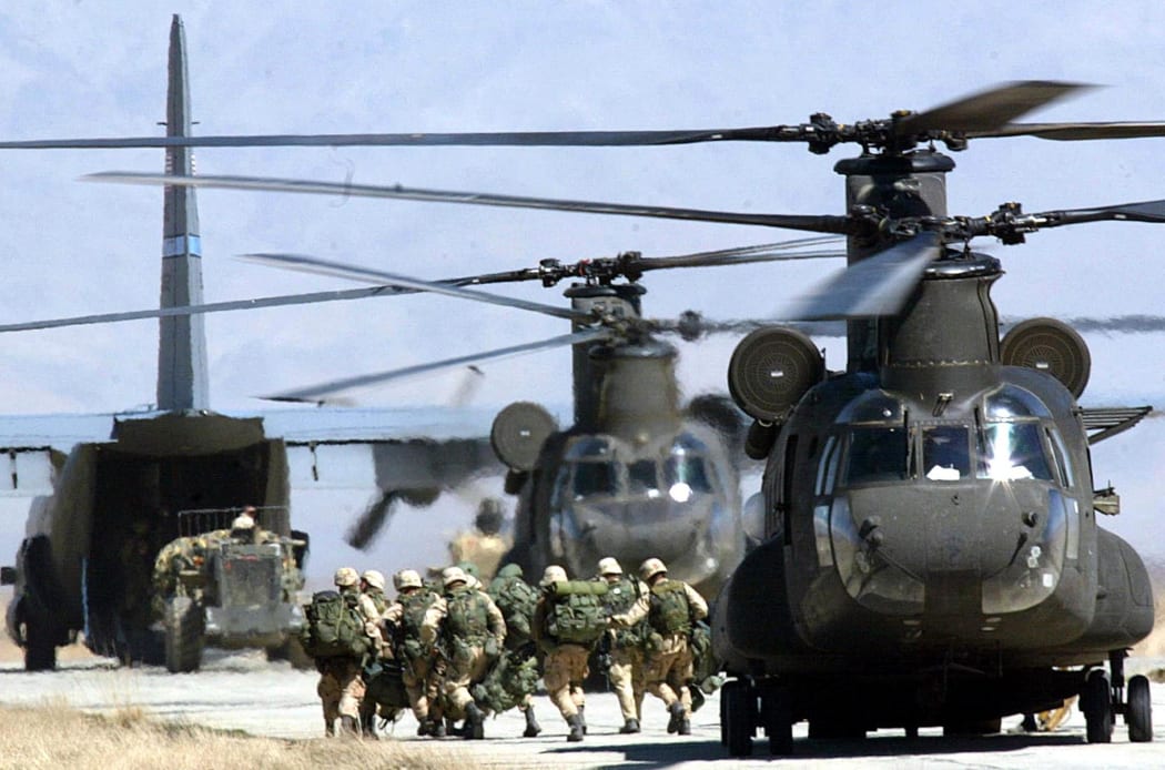 US soldiers disembark from a helicopter at Bagram Air Base on March 12, 2002.