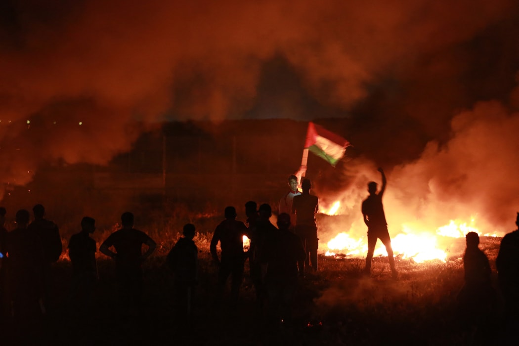 Demonstrators burn tires at the Israeli border east of the Gaza Strip on 9 May, after clashes between Israeli forces and palestinians.