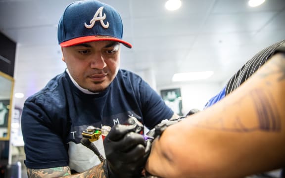 Leroy Roberts of Maia Ink tattooing a client