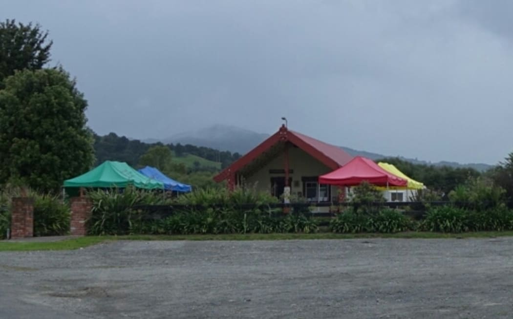 Colourful tents in front of the wharenui at Hiruharama Marae near Ruatoria, as it prepares to hold a tangi for Whairiri Ngata.