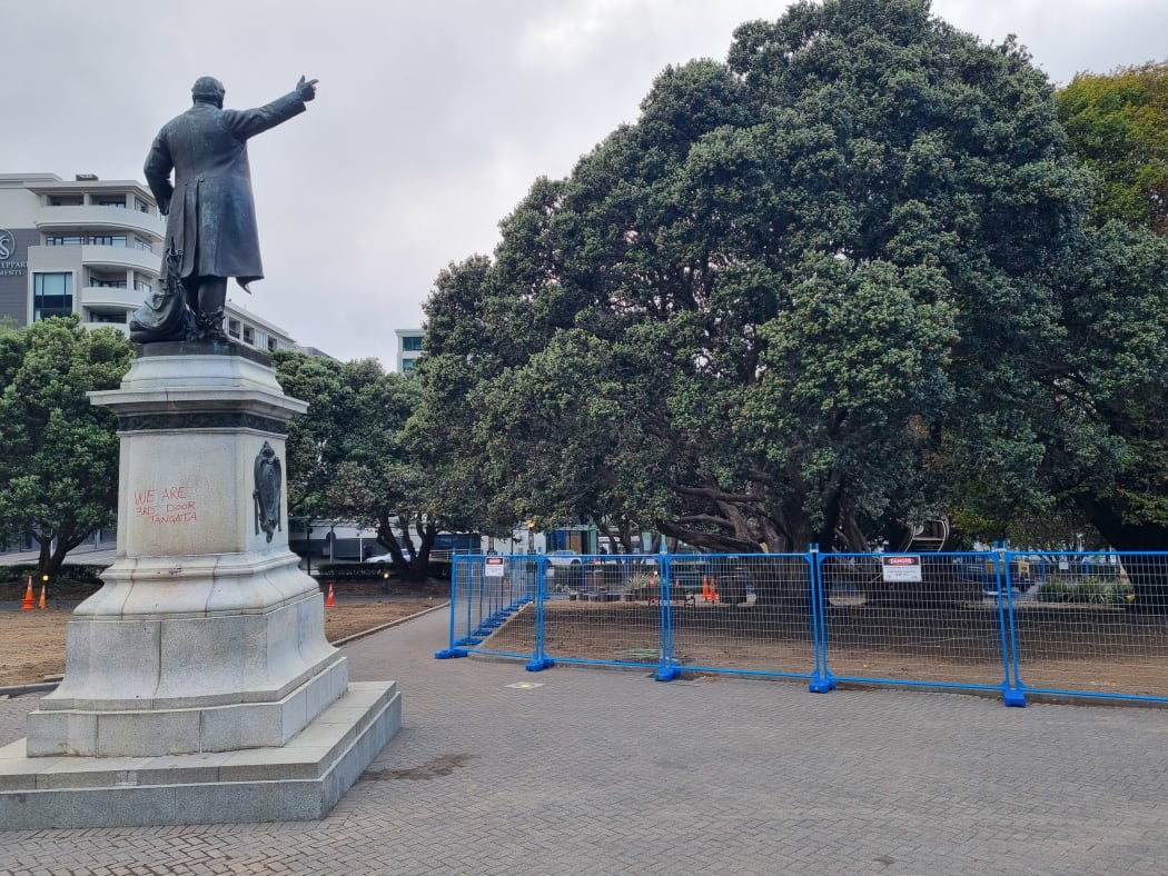 Fences remain around Parliament's lawn as it regrows and the playground is still closed off.