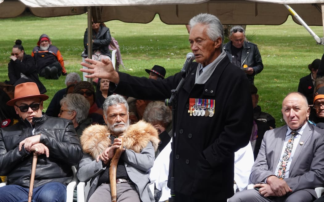 Kaumātua Matutaera Clendon speaks to the crowd gathered outside Te Whare Rūnanga.