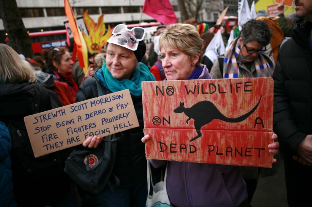 Members of climate change activist movement Extinction Rebellion (XR) protest the Australian government's response to its ongoing bushfires emergency at a demonstration outside the Australian High Commission in London, England.