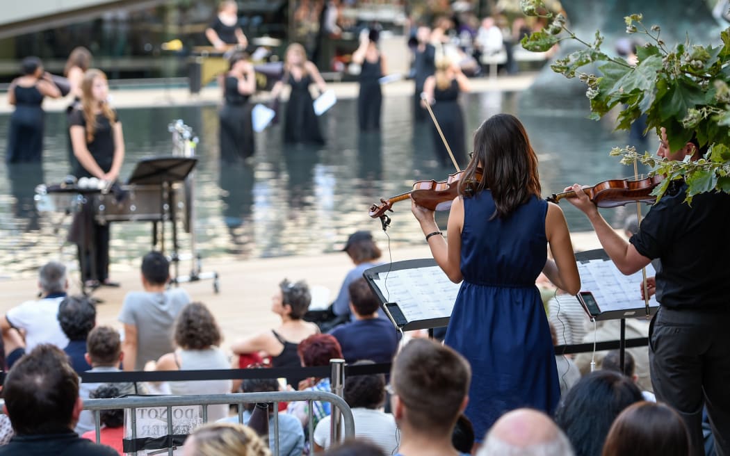 An orchestra plays on the waterfront.