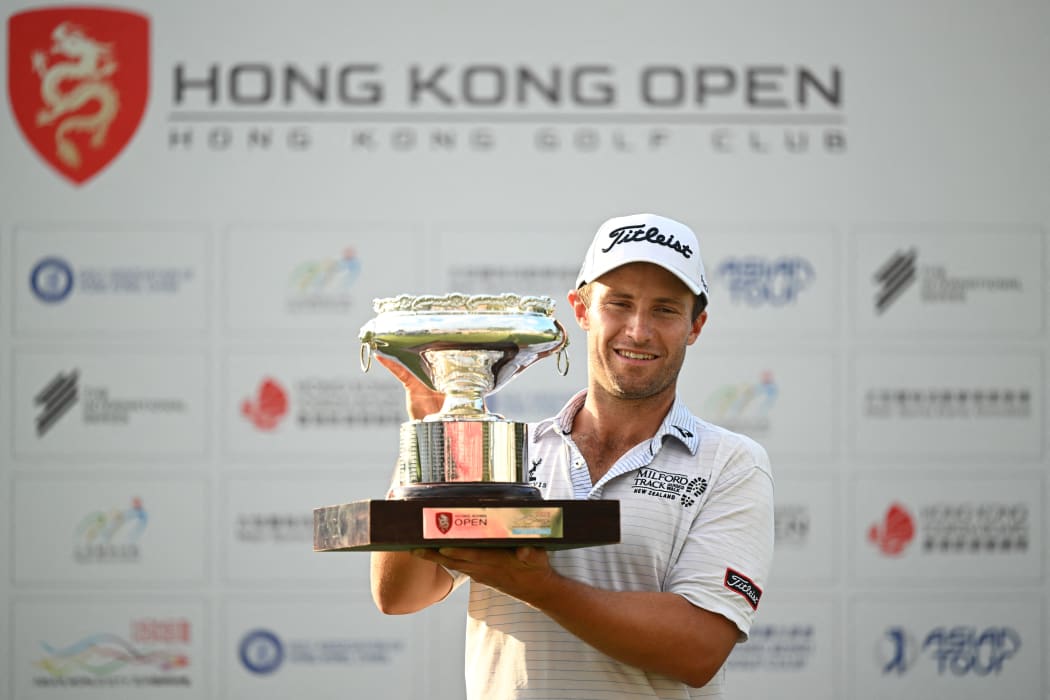 New Zealand's Ben Campbell celebrates with the winner's trophy after his victory on the final day of the Hong Kong Open at Fanling golf club in Hong Kong on November 12, 2023. (Photo by Peter PARKS / AFP)