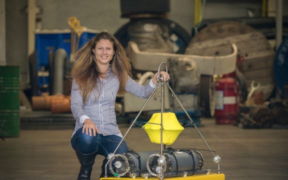 Marine ecologist Kim Goetz with one of the acoustic moorings she is deploying in Cook Strait to eavesdrop on whales and dolphins.