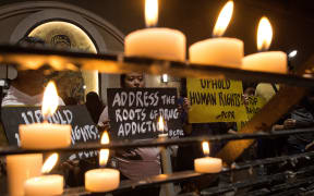 Human rights advocates hold placards condemning extra judicial killing after a mass at the Redemptorist Church in Manila on 10 August 2016.