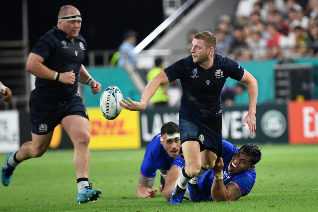 Scotland's fly-half Finn Russell (R) set up their first two tries.