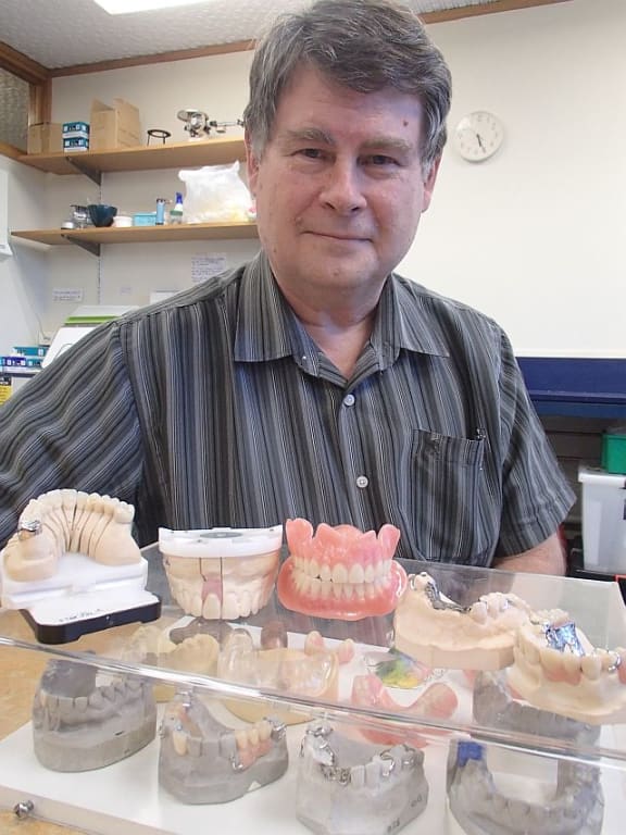 Dental technologist Neil Waddell says that making whole or partial dentures and replacement teeth is both an art and a science. Neil with range of dentures and dental devices.