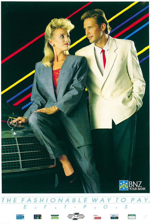 An image of a poster advertising EFTPOS. Two sharply dressed people lean against the bonnet of an expensive car. The caption reads "the fashionable way to pay."