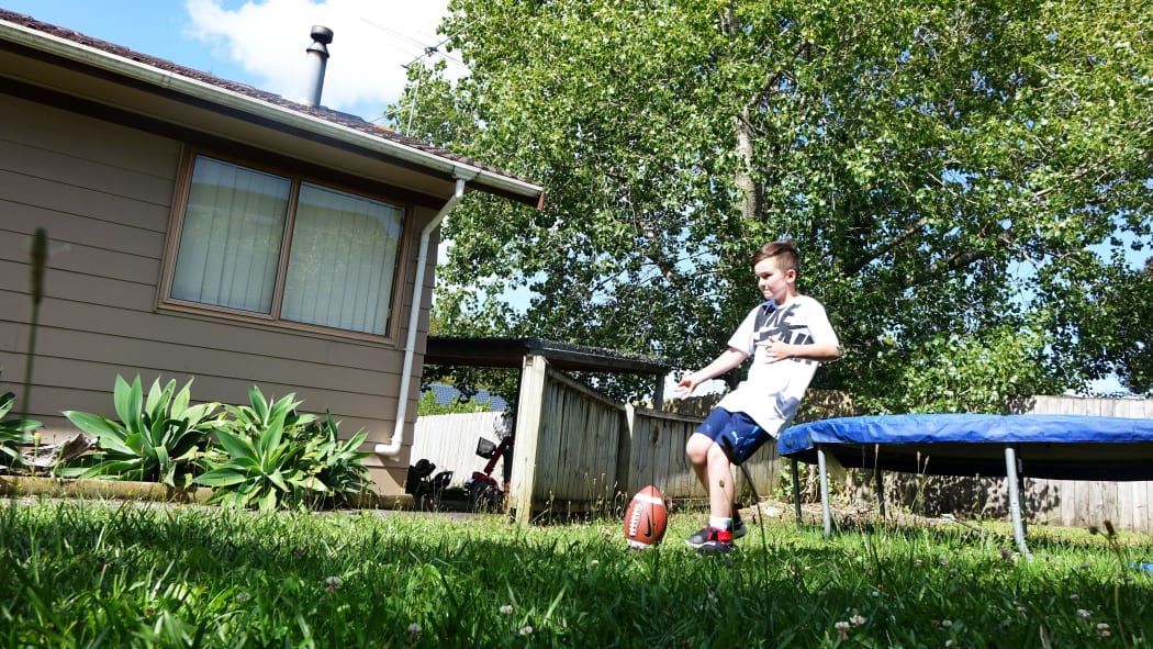 Trans boy Ben in his back yard