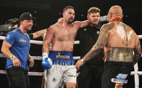 New Zealand's Joseph Parker is embraced by his brother John (left) and trainer Taylor Barry after defeating American Alexander Flores last year.