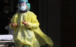 A medical worker walks outside of a special coronavirus intake area at Maimonides Medical Center on April 10, 2020 in New York City.