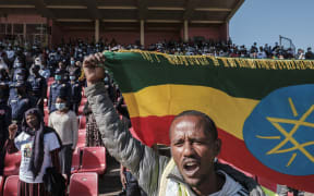 A man holds an Ethiopian national flag during a blood donation rally in Addis Ababa, as hundreds of Ethiopians gathered in the capital on 12 November 2020, to donate blood for troops fighting in the northern Tigray region.