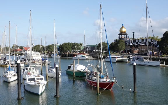 Yachts moored at Whangārei Town Basin with the Hundertwasser Arts Centre in the background